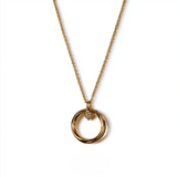 Eterna Aura Pendant – A refined emblem of quiet luxury. The Eterna Aura Pendant blends sculptural minimalism with an intimate romantic touch: a perfectly polished golden circle embracing a pavé-set heart charm. Its fluid contours catch the li